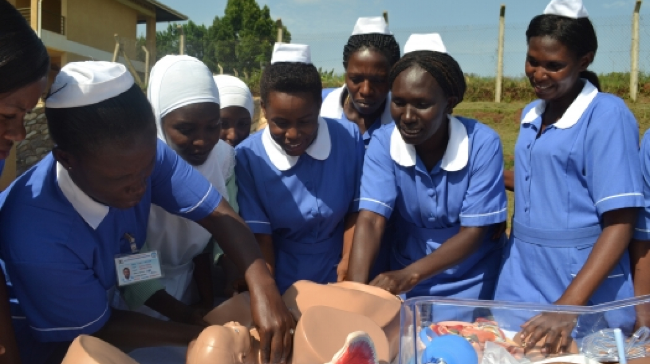 Trainee midwives demonstrating the childbirth process using a birth simulator in Kampala, Uganda.  Photo: UNFPA/Evelyn Kiapi