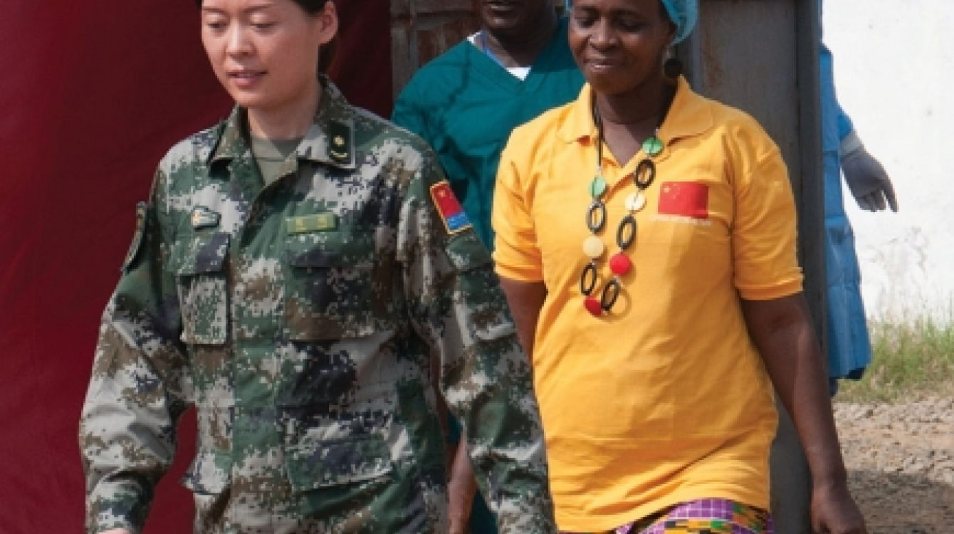 Beatrice Yardolo, right, Liberia’s last Ebola patient, walks out of the Chinese Ebola Treatment Unit (ETU) in Monrovia, Liberia, at the beginning of a short ceremony celebrating her survival and release from the ETU on March 5. Photo: UNMEER/Simon Ruf