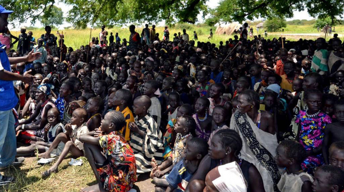 Aid workers register a community affected by hostilities in Jonglei State and explain the process to them which is important to provide food and other assistance. (August 2013) Credits: IOM