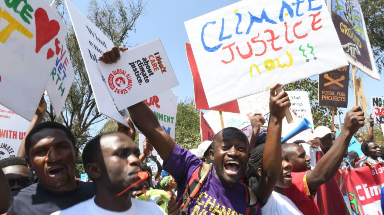 Environmental activists carrying placards protest calling for action on climate change, in Nairobi 