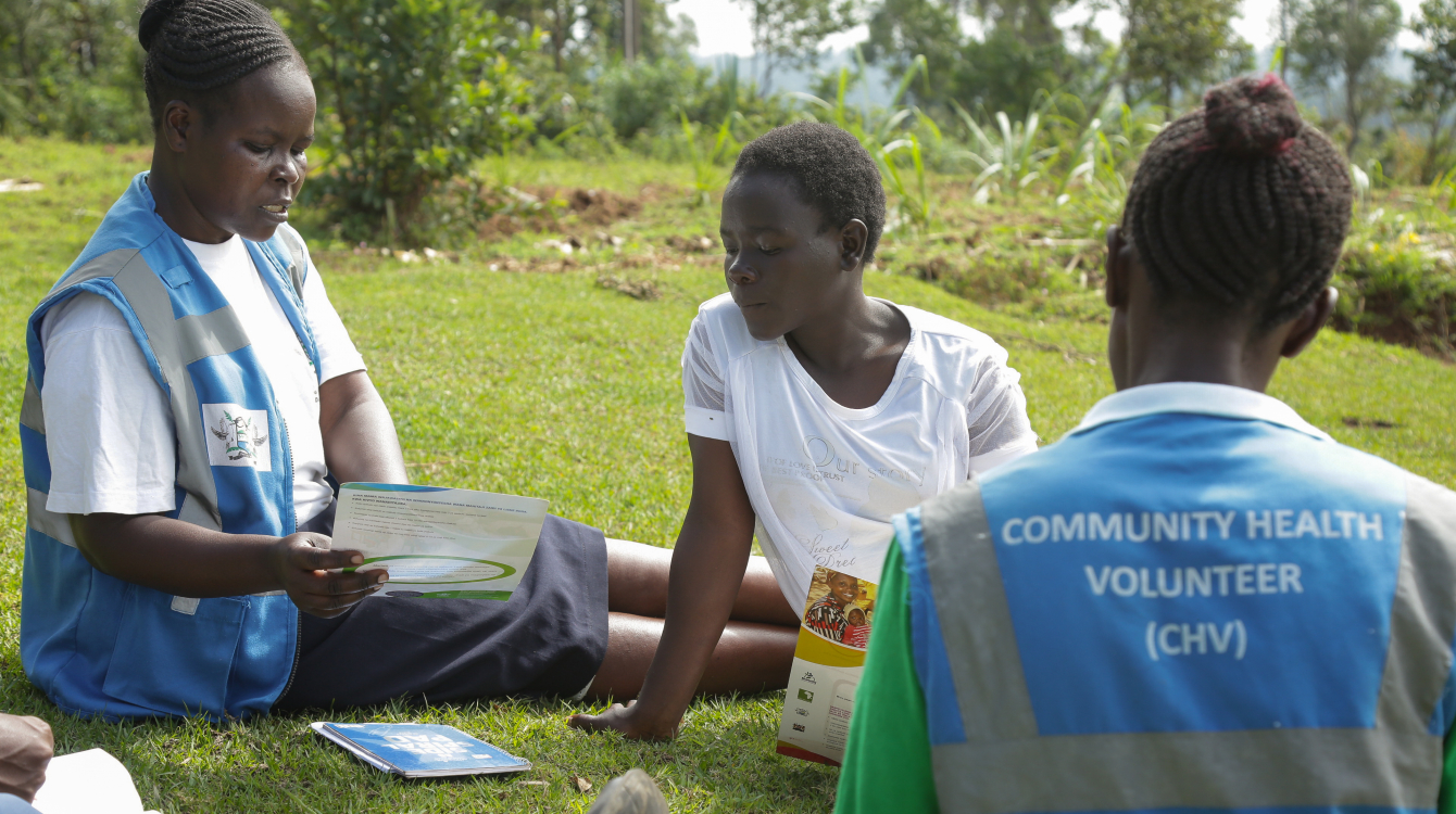 Community health volunteers attending to Delourice.