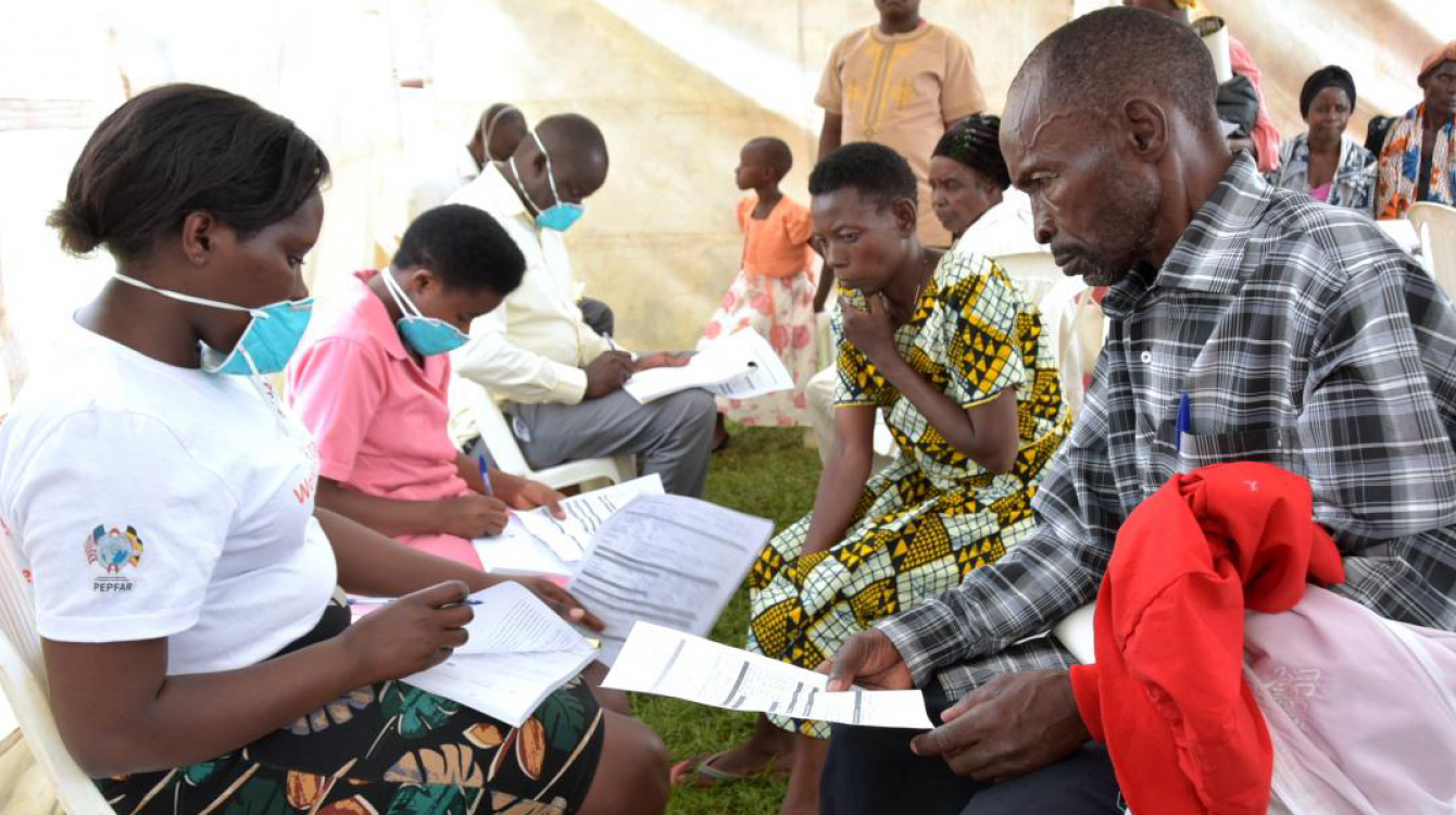Health workers receiving members of the public for TB screening in Uganda.