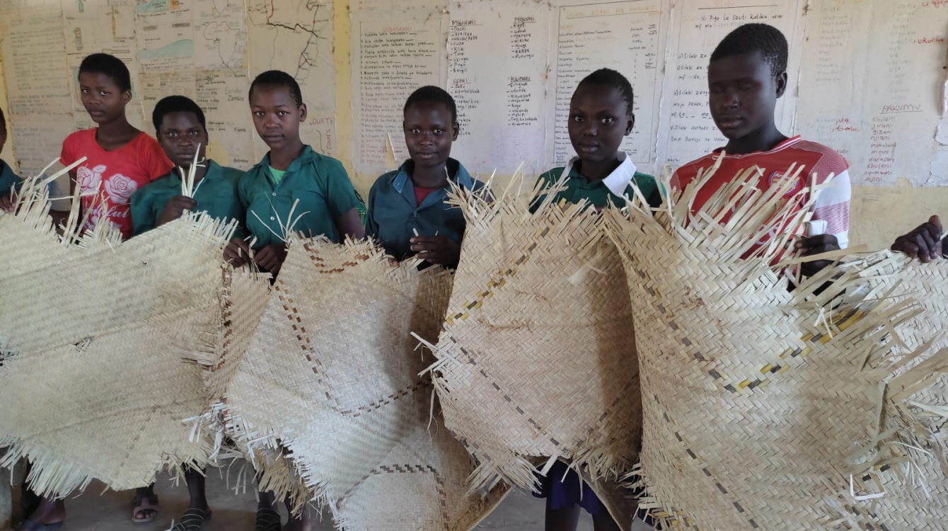 Some of the girls who board in the school display their beddings.