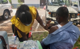 Health worker vaccinating a client in the Kumasi in the Ashanti Region of Ghana