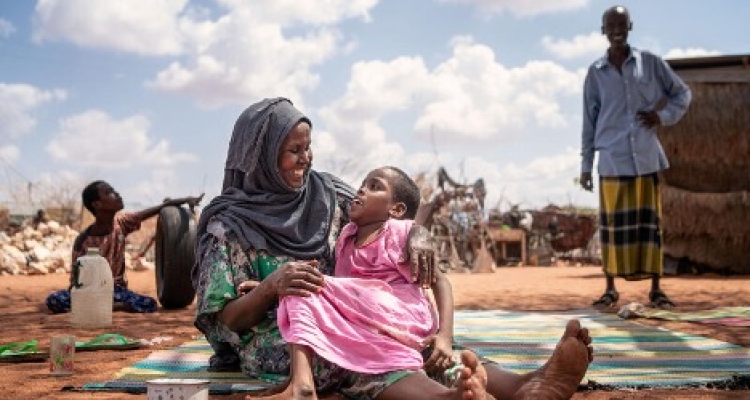 Mother holding her daughter.