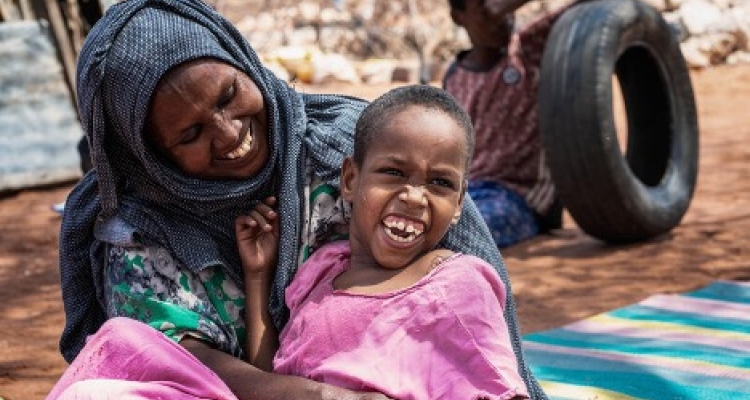 Smiling mother holding her daughter