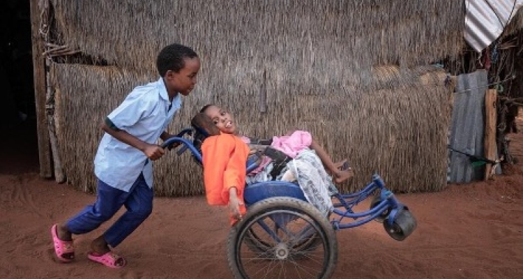 Hassan taking his sister Ikran for a ride in her wheelchair