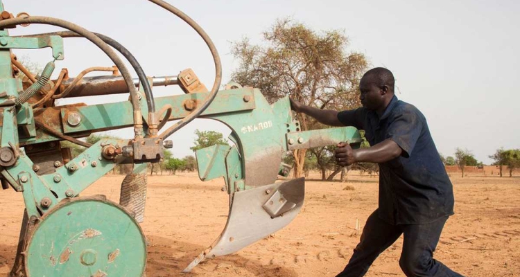 Workers preparing tractors to start ploughing in Burkina Faso.