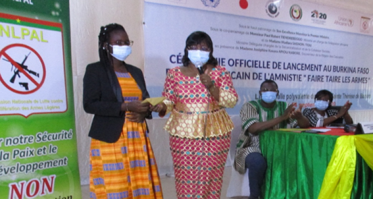 Mireille Armelle Ilboudo/Bamogo, 29, receives her prize as the winner of a slogan contest held in Banfora, Burkina Faso.