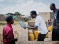 An official checks data from an internet-based water monitoring device at a borehole in Basbedo, Burkina Faso. Photo: Panos/Andrew McConnell