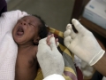 A nurse takes blood sample from a baby to test for malaria in Manhia, Mozambique. AMO/ L. W.