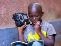 Igihozo, 11, listens to a lesson on a radio after his school was closed in Rwanda.