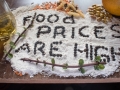 Spelled out with black pepper seeds on a flour with lentils and other food in the background.