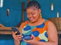 African woman entrepreneur with digital payment device.