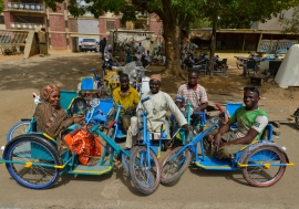 Survivors of polio in Kano State, Nigeria, sit on tricycles specially designed for people with disabilities.