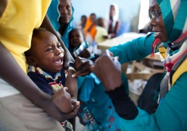 A child receives a vaccination against meningitis at the community centre in Al Neem camp for Internally Displaced People in El Daein, East Darfur, Sudan. Photo: UNAMID/Albert González Farran