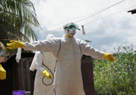 The Ebola burial team gets disinfected and can then remove their personal protective equipment safely.