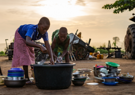 Girls washing dishes in Lome, Togo.