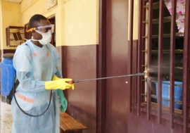 A volunteer disinfecting the hospital of Tahouay in Conakry, Guinea.  Photo: Afreecom/Idrissa Soumaré
