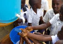 Learning that handwashing is among the best ways to protect yourself against Ebola, school children in Beni, DR Congo visit a UNICEF hand-washing station at their school. Photo Credits: UNICEF/Thomas Nybo