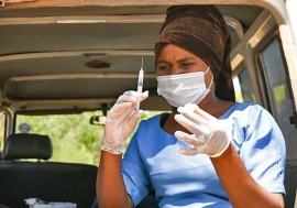 A health worker prepares to administer COVID-19 vaccines.