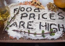 Spelled out with black pepper seeds on a flour with lentils and other food in the background.