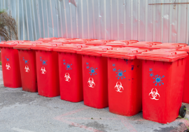 Red bins group with symbol infectious in the ...