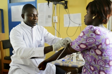 A laboratory studies student taking a blood sample for a routine antenatal malaria test at a government hospital in Ghana. Photo credit: Panos/Nyani Quarmyne