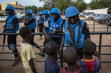 Peacekeepers with the United Nations Multidimensional Integrated Stabilization Mission in Mali (MINUSMA) are greeted by children. Photo: MINUSMA/Marco Dormino