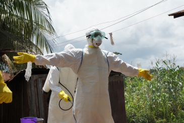 The Ebola burial team gets disinfected and can then remove their personal protective equipment safely.