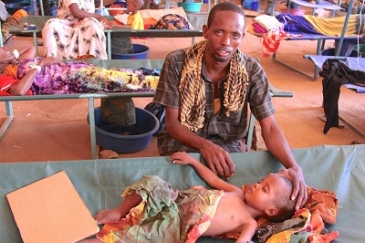 Nur Ismail, 3, is treated for acute watery diarrhoea at the cholera treatment centre in Bay Regional Hospital, Baidoa, Bay region. His father, Hassan Ismail, is by his side. UNICEF/UN057221/Makundi