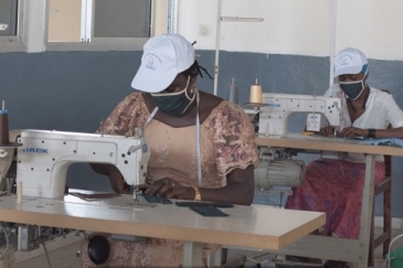 Young tailors in Guinea stitching masks