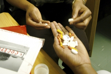 A patient discussing medication with a doctor at HIV/AIDS unit in Botswana. AMO/ Eric Miller