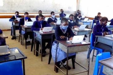 Botswana students and their teacher in a computer lab/Tiya Siyapo.