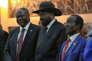 Salva Kiir, President of South Sudan, (centre right) shakes hands with Riek Machar, who was sworn in as First Vice President of the new Transitional Government of National Unity on 22 February 2020.