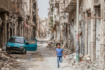 A child runs through the debris and wreckage in downtown Benghazi, Libya.