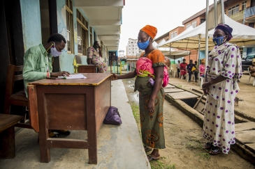 Women in Nigeria collect food vouchers as part of a programme to support families in difficulty