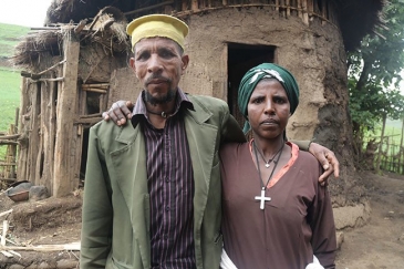 Mrs. Belay with her husband, Priest Leul Hunegnaw, in front of their barn. She says contraception has had a liberating effect.