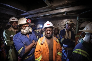 Miners in a lift cage at the Chambishi copper mine in Kitwe, Zambia. Photo: Panos/Sven Torfinn