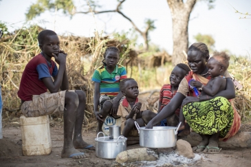 Sudanese refugee Amal Bakith cooks the first breakfast for her children a day after arriving in Ajuong Thok camp, South Sudan. During their long journey from South Kordofan, they had only rotten food to eat. Photo: UNHCR/Rocco Nur