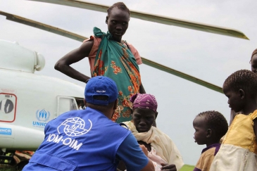This photo from November 2014 shows IOM providing transportation assistance in South Sudan, moving vulnerable refugees on a UNHCR helicopter. Photo: IOM