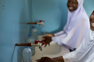 Photo: UNICEF/Kate Holt.  Students in Tanzania enjoy fresh water for drinking, washing and cooking.