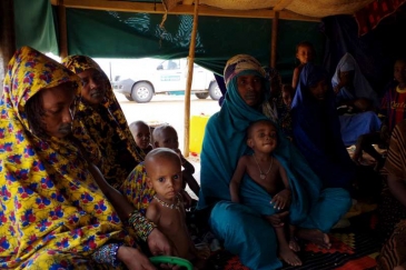 New arrivals from Mali sit inside one of the tents at Mbera Camp, some 50 kilometres inside Mauritania