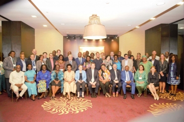 UNDP Administrator Achim Steiner, seated, at center in group photo with around 40 people.