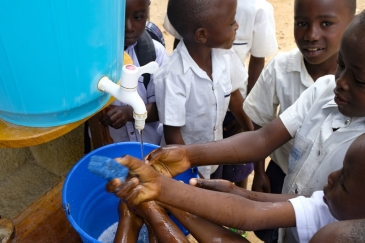 Learning that handwashing is among the best ways to protect yourself against Ebola, school children in Beni, DR Congo visit a UNICEF hand-washing station at their school. Photo Credits: UNICEF/Thomas Nybo