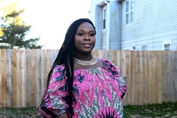 Lourena Gboeah in front of her home