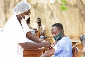 Man receiving COVID-19 vaccine.