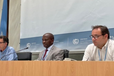 Mr. Ephraim Mwepya Shitima of Zambia, at center, between two other meeting participants.