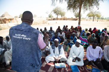 CRS staff addressing the community in Hashaba village, West Darfur, Sudan.