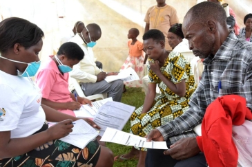 Health workers receiving members of the public for TB screening in Uganda.